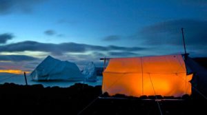 Tents at night near an iceburg